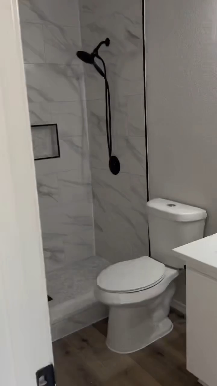 Walk through of a bathroom renovation with a new tile shower, vanity, and flooring
