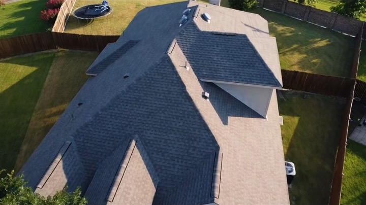 Drone and ground walk through of a completed roof replacement on a brick single-family home